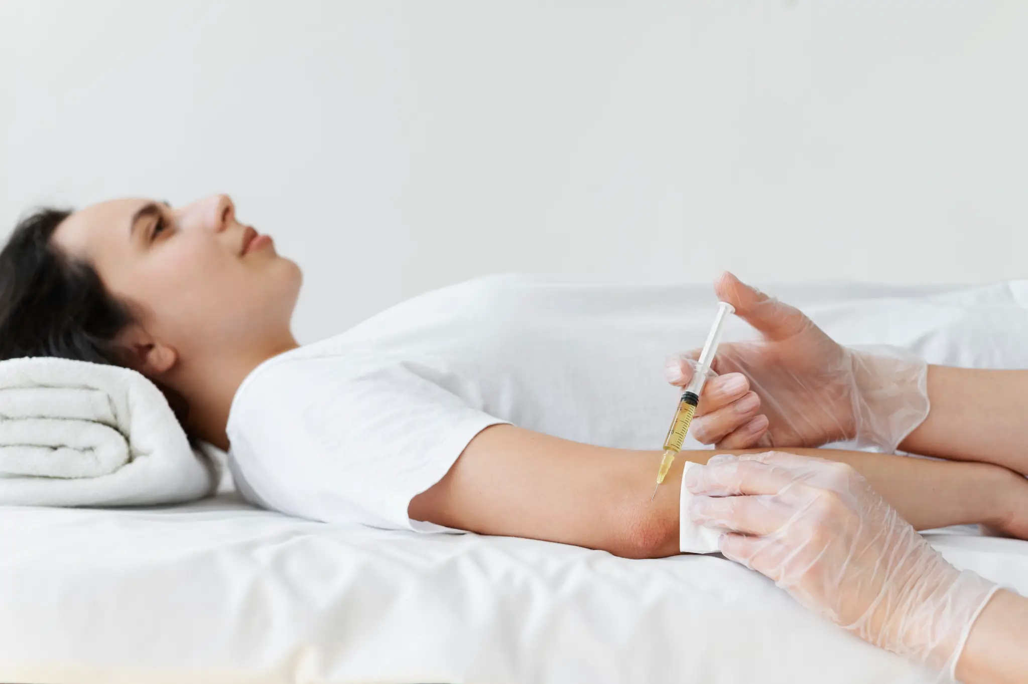 Medical professional administering an injection into a patient’s arm | Exosome therapy