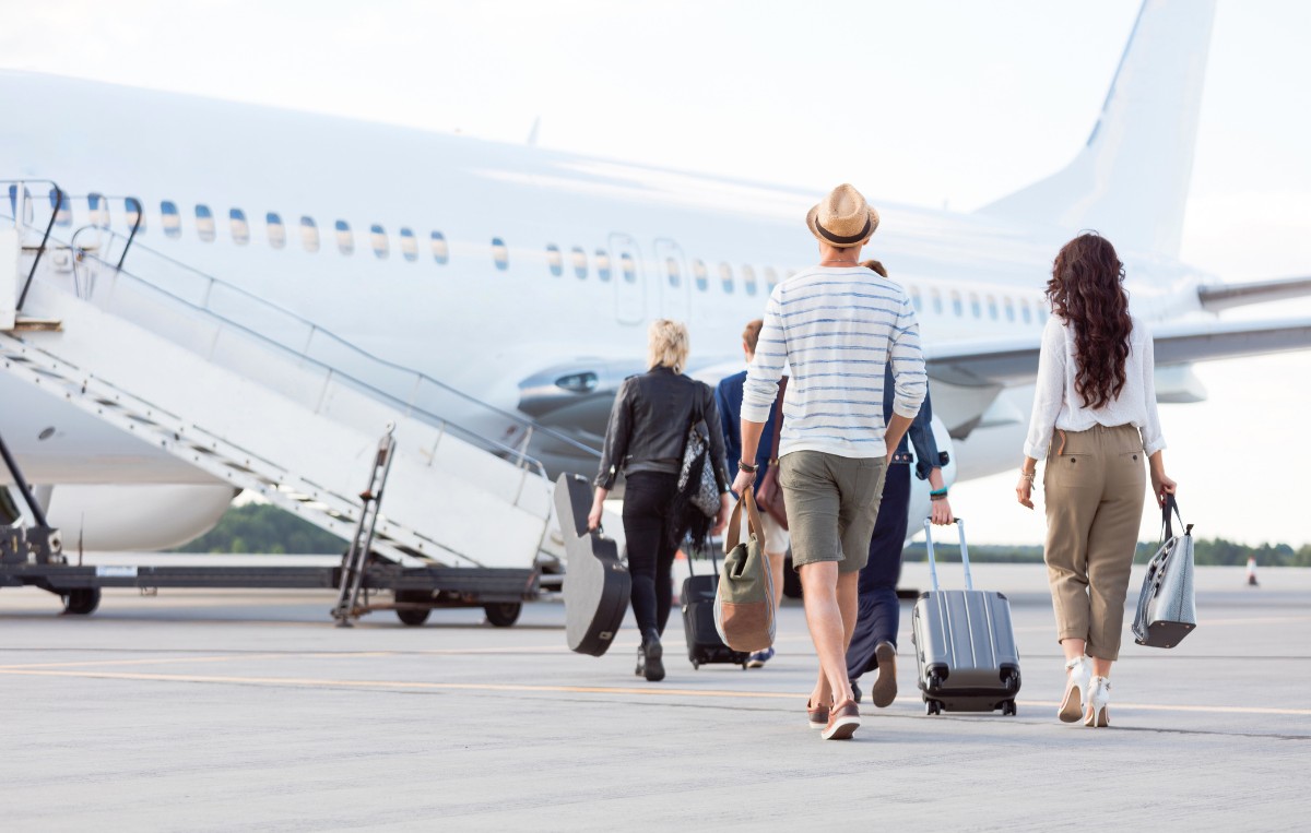 group of travelers carrying luggage